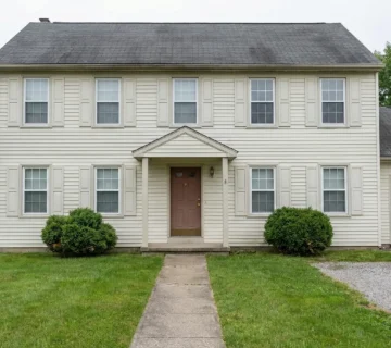 Don't Settle for Beige: See 12 Incredible Exterior Makeovers of This Colonial Home